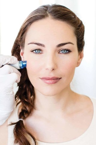 HydraFacial patient during procedure displaying refreshed, brilliant skin on face