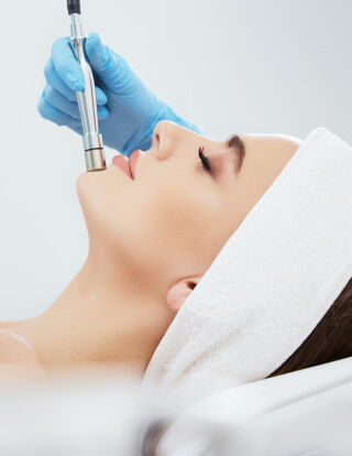 Microdermabrasion patient during procedure showing glowing, smooth, rejuvenated facial skin