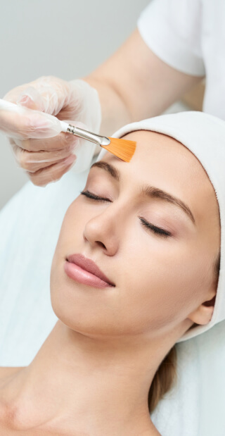a chemical peel patient during procedure. a layer is brushed on before removing to reveal smooth refreshed skin