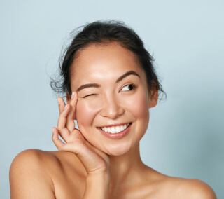 Skin Rejuvenation model smiling showing radiant, wrinkle-free skin
